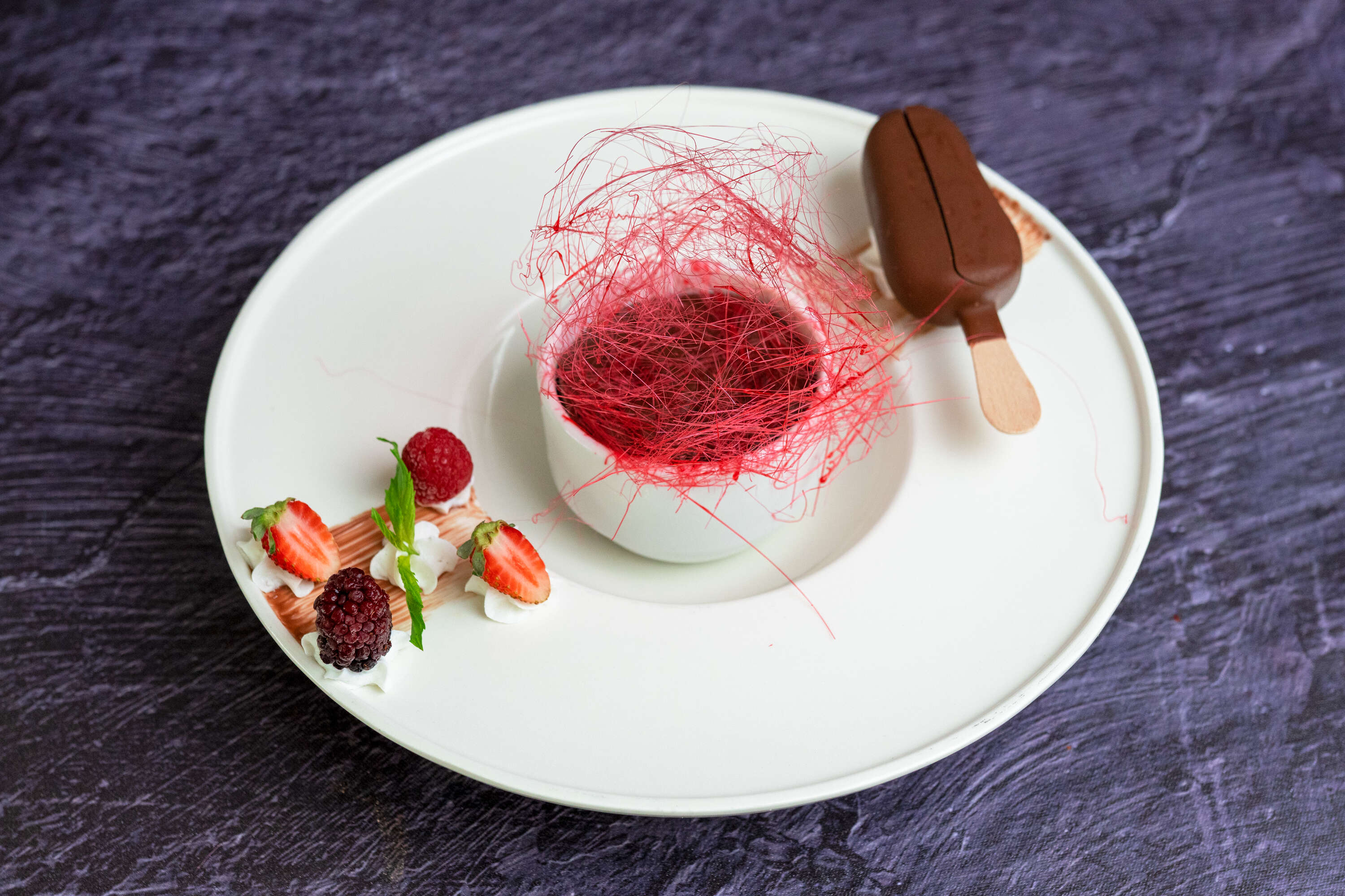 Chocolate soufflé with strawberry, banana, praline and Mini Magnum