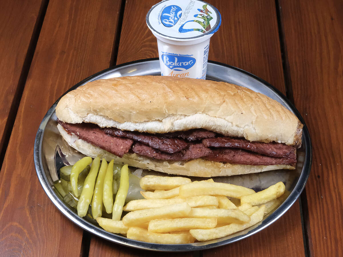Beef sucuk sandwich, tomato, ayran, and French fries