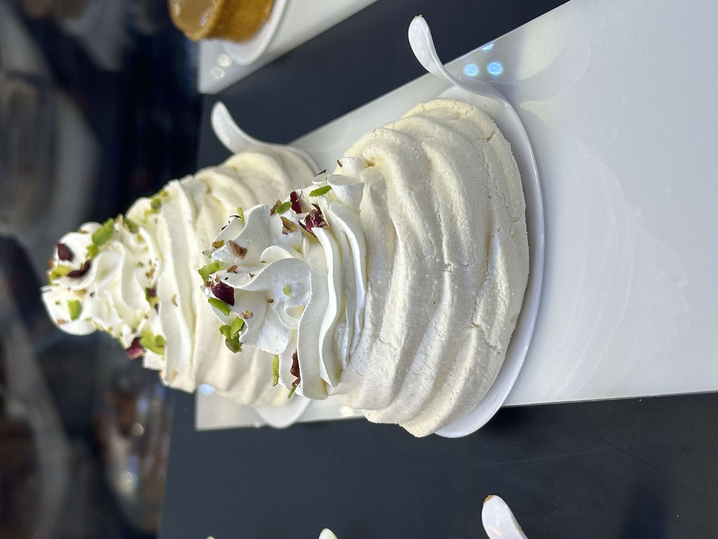 Pavlova with lemon cream, cherry filling, and homemade whipped cream
