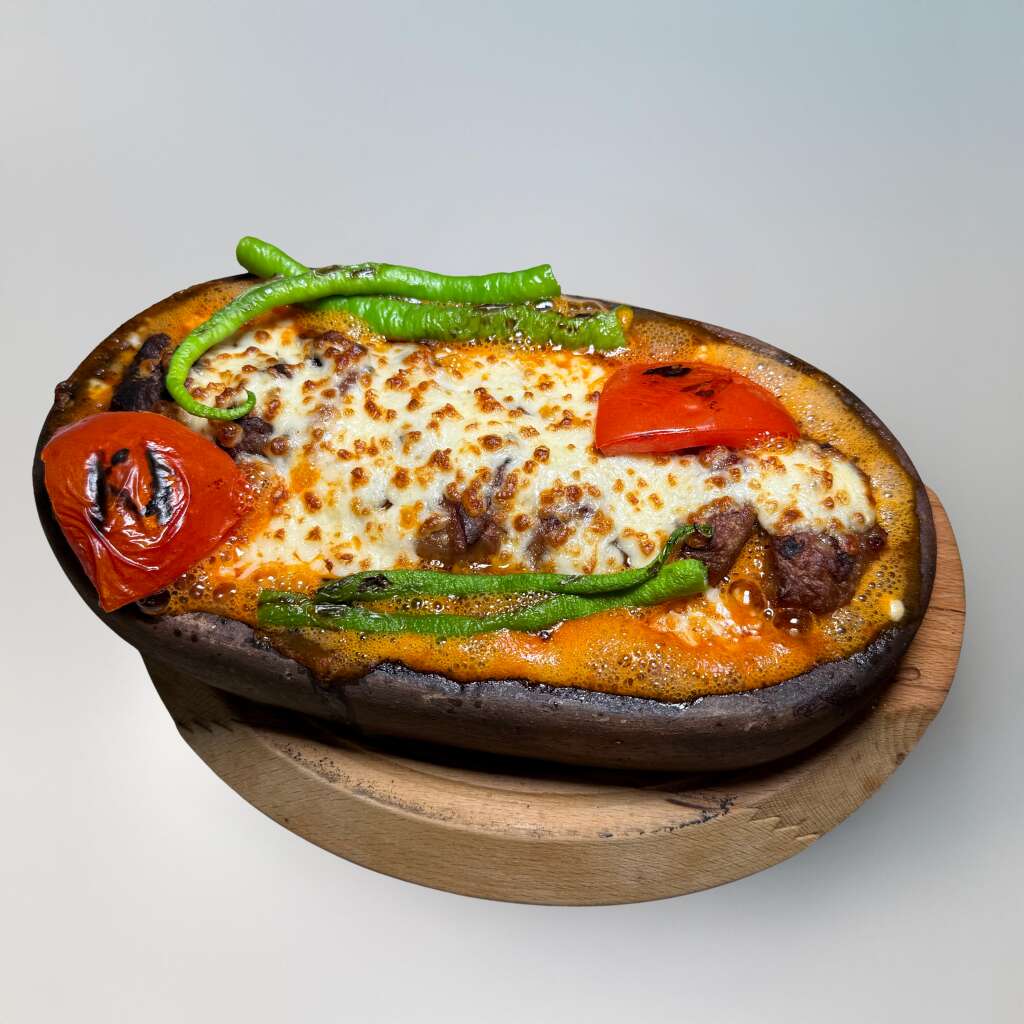 Cheese-Topped Meatballs in a Clay Dish